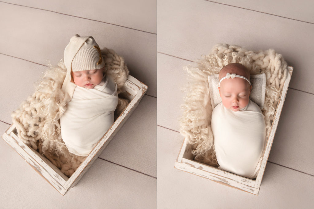 twins lay in wooden box with tan blanket